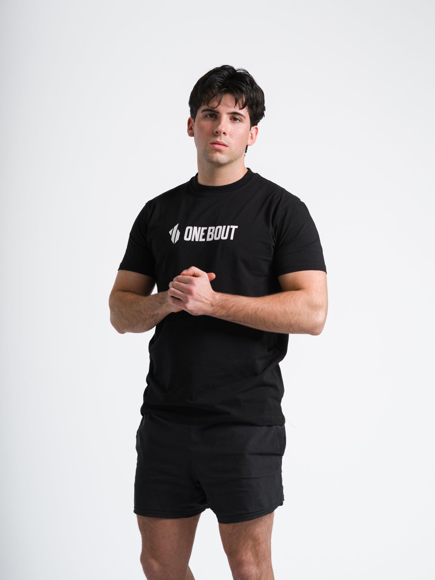 Man wearing a black t-shirt with 'ONE BOUT' logo on a white background