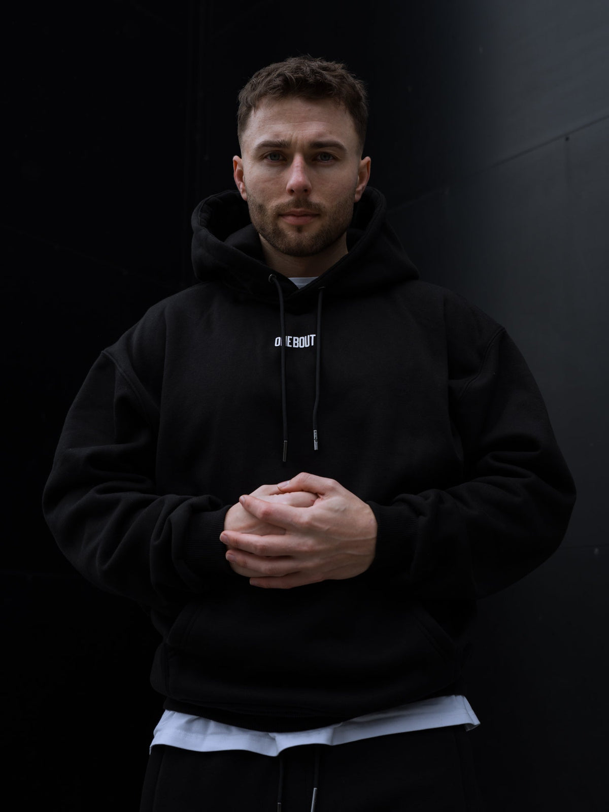 ONE BOUT Script Collection — black hoodie, t-shirt and bottoms close-up