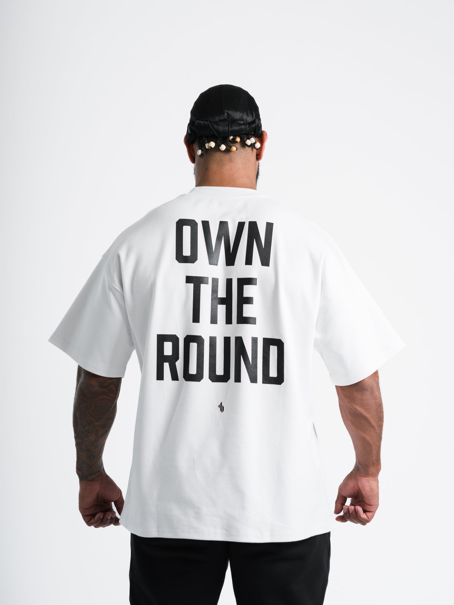 Male model wearing white ONE BOUT OWN THE ROUND Oversized T-Shirt back view