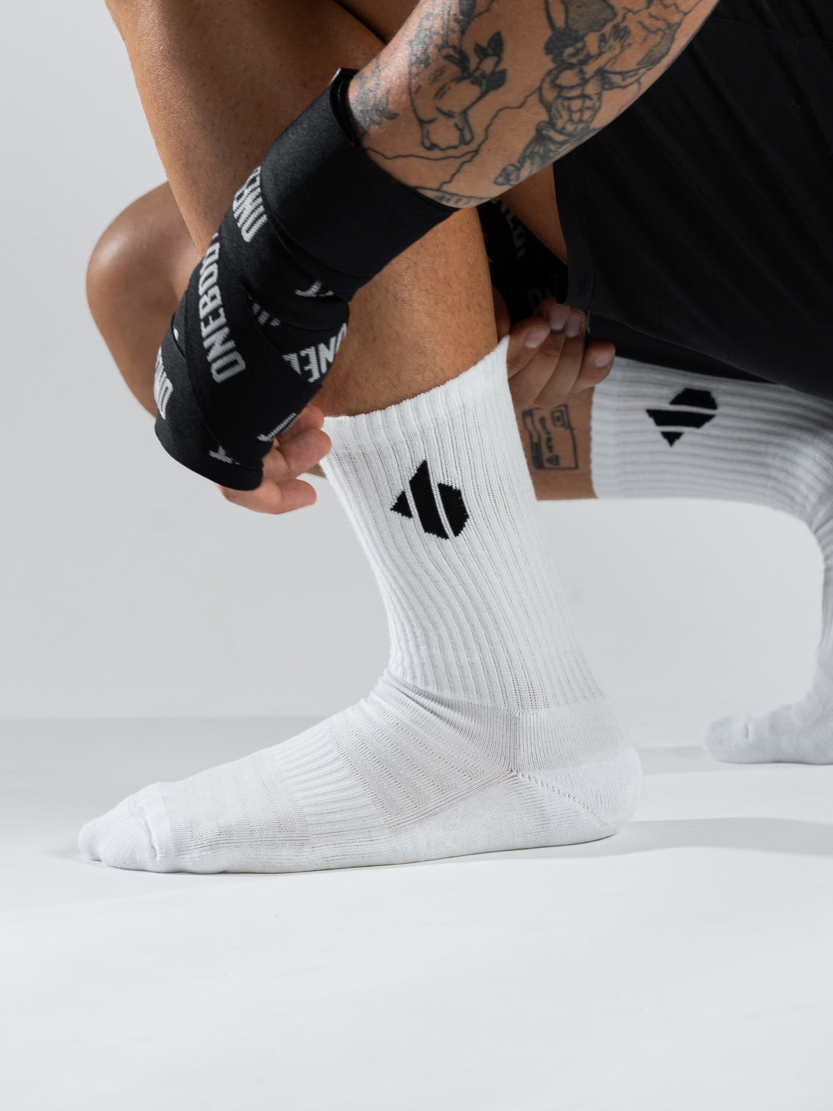 One Bout Crew Socks in white — worn during training, side view