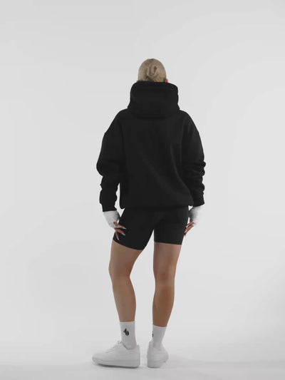 Female model in black ONE BOUT Script Oversized Hoodie Limited edition — fit and movement