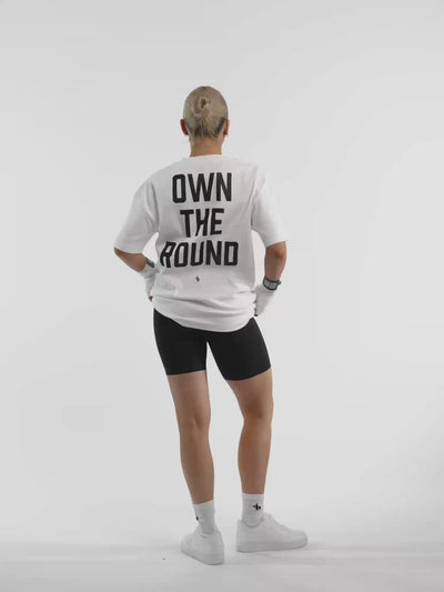 Female model in white ONE BOUT Own The Round oversized t-shirt — fit and movement
