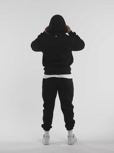 Male model in black ONE BOUT Script Oversized Hoodie — fit and movement