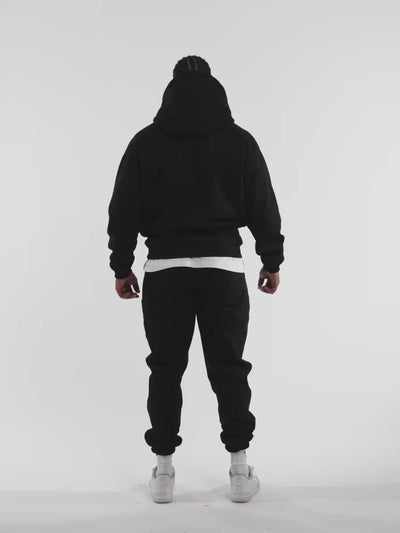 Male model in black ONE BOUT Script Bottoms — fit and movement