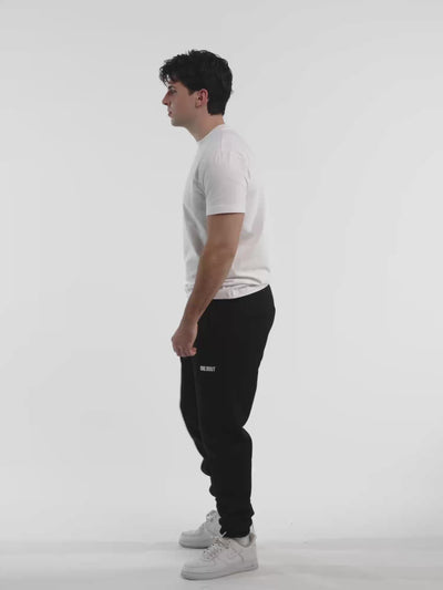 Male model in white ONE BOUT Script T-Shirt — fit and movement