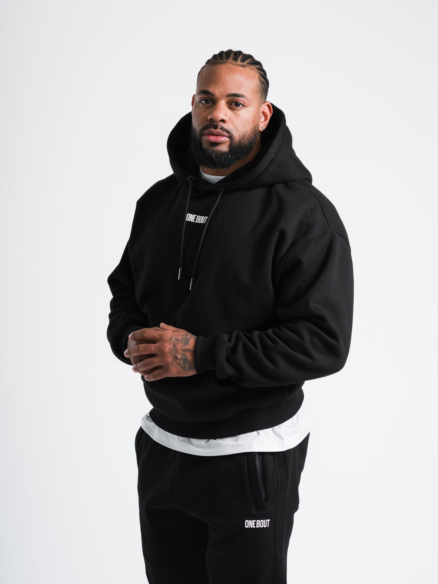 Male model wearing black ONE BOUT Script Oversized Hoodie