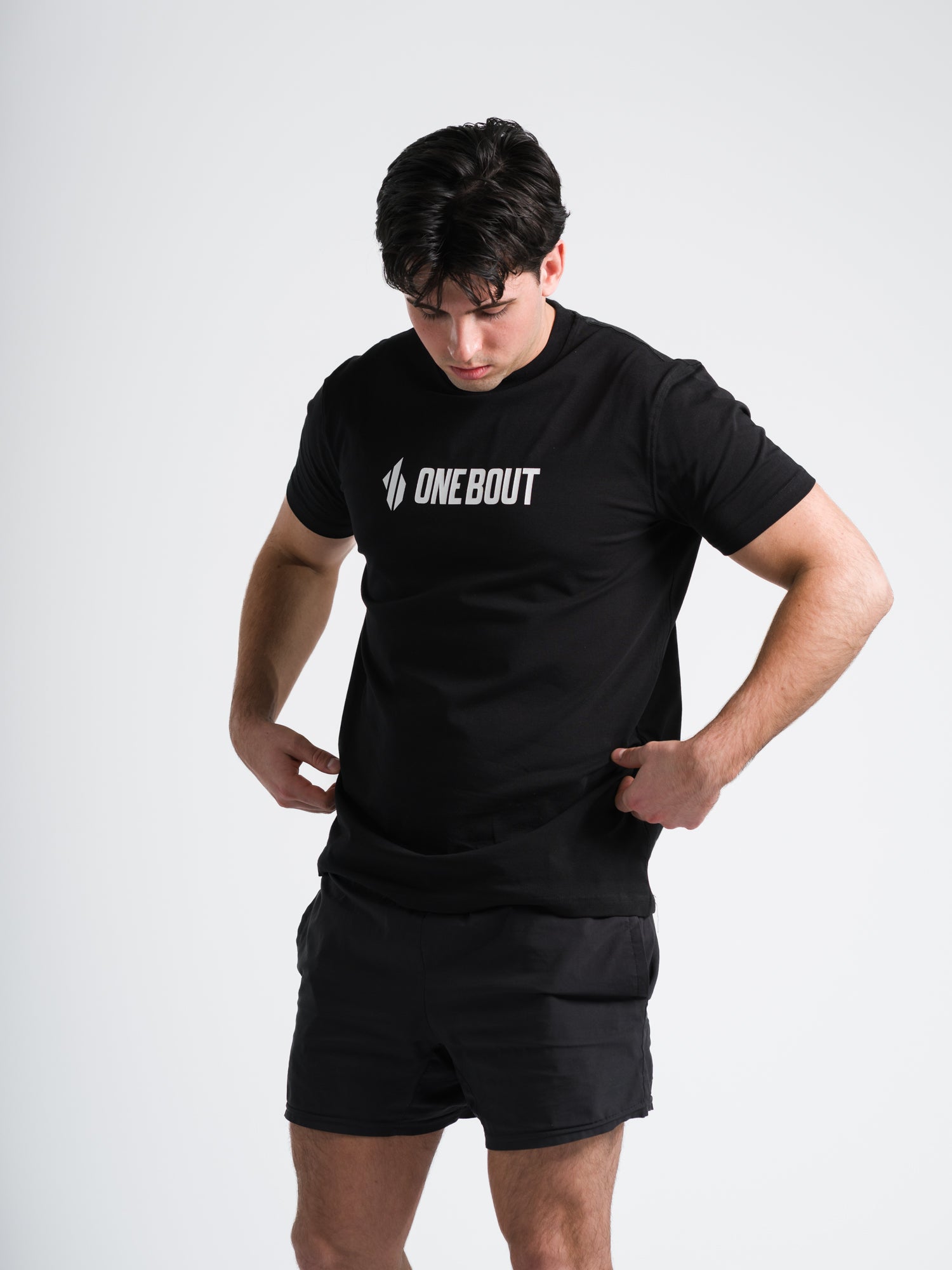 Male model wearing black ONE BOUT Line T-Shirt with enlarged chest logo